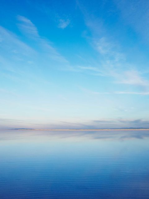 water and sky with wispy clouds