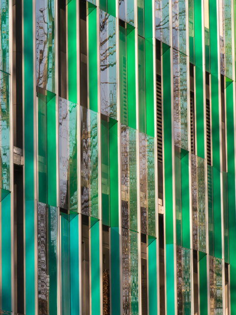 Public office building with colorful graduated shading in turquoise and green