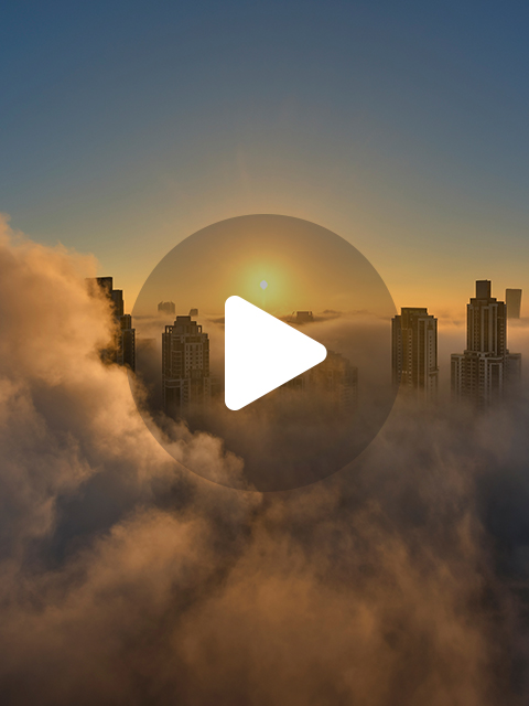 Cityscape during sunrise with COP28 logo overlay