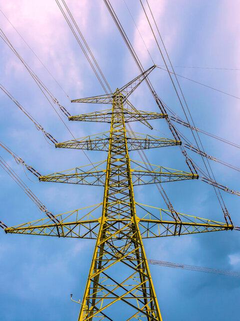 Tall electricity pylon with dark clouds