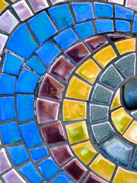 A spiral arrangement of multi-colored mosaic tiles