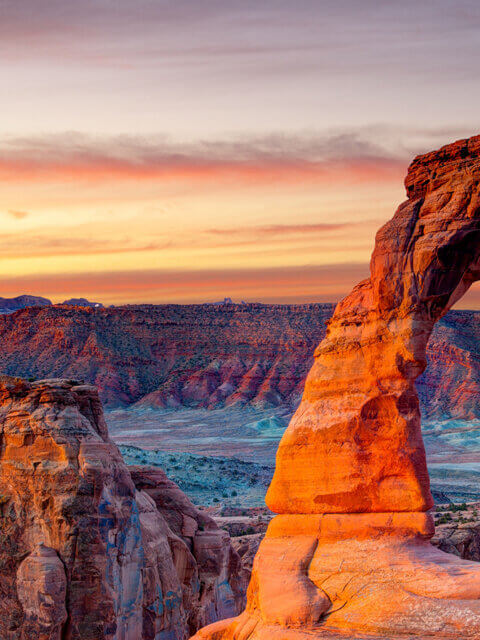 Glowing stone arch at sunset, Arches National Park, UT